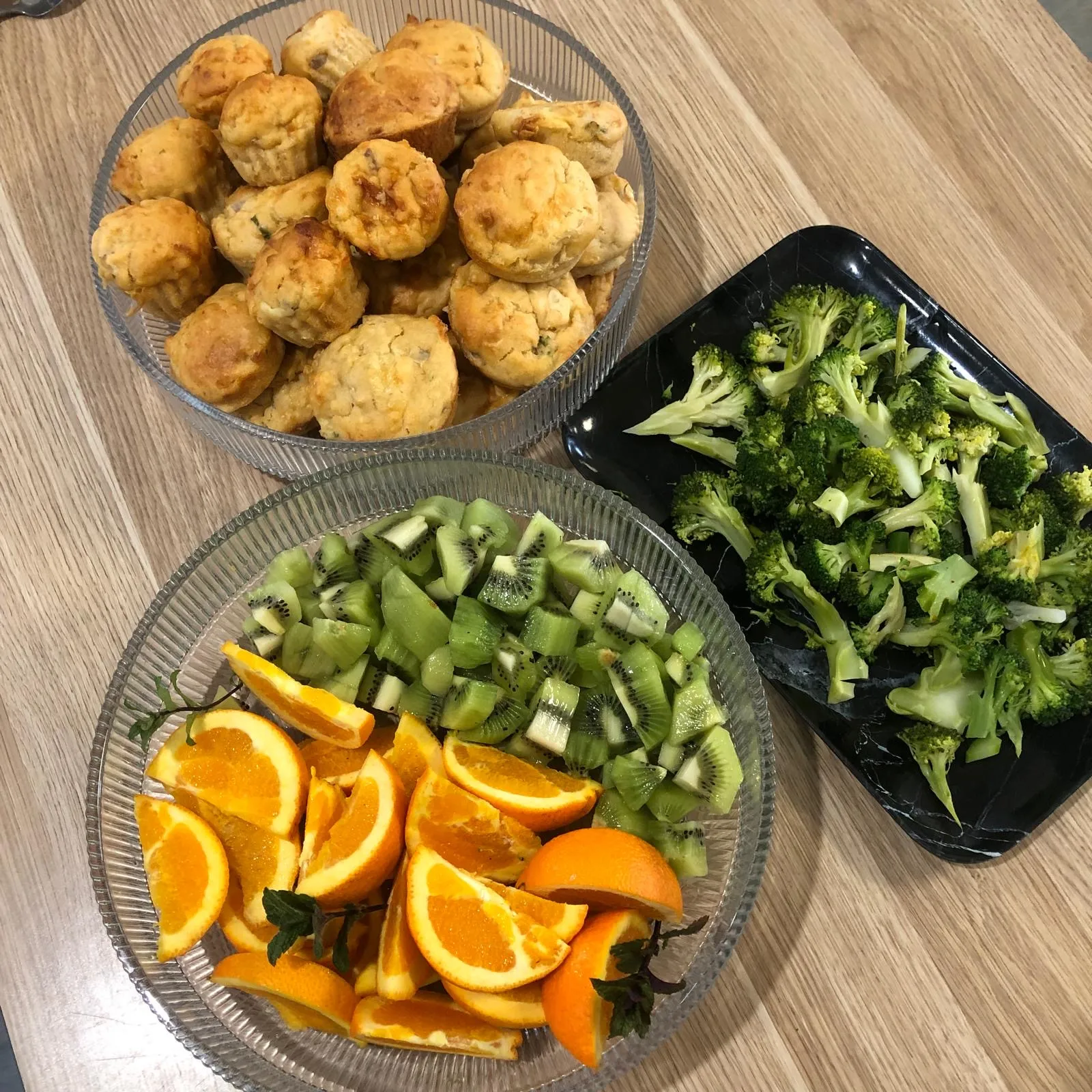 Savoury muffins baked on site with kiwifruit, orange slices and steamed broccoli