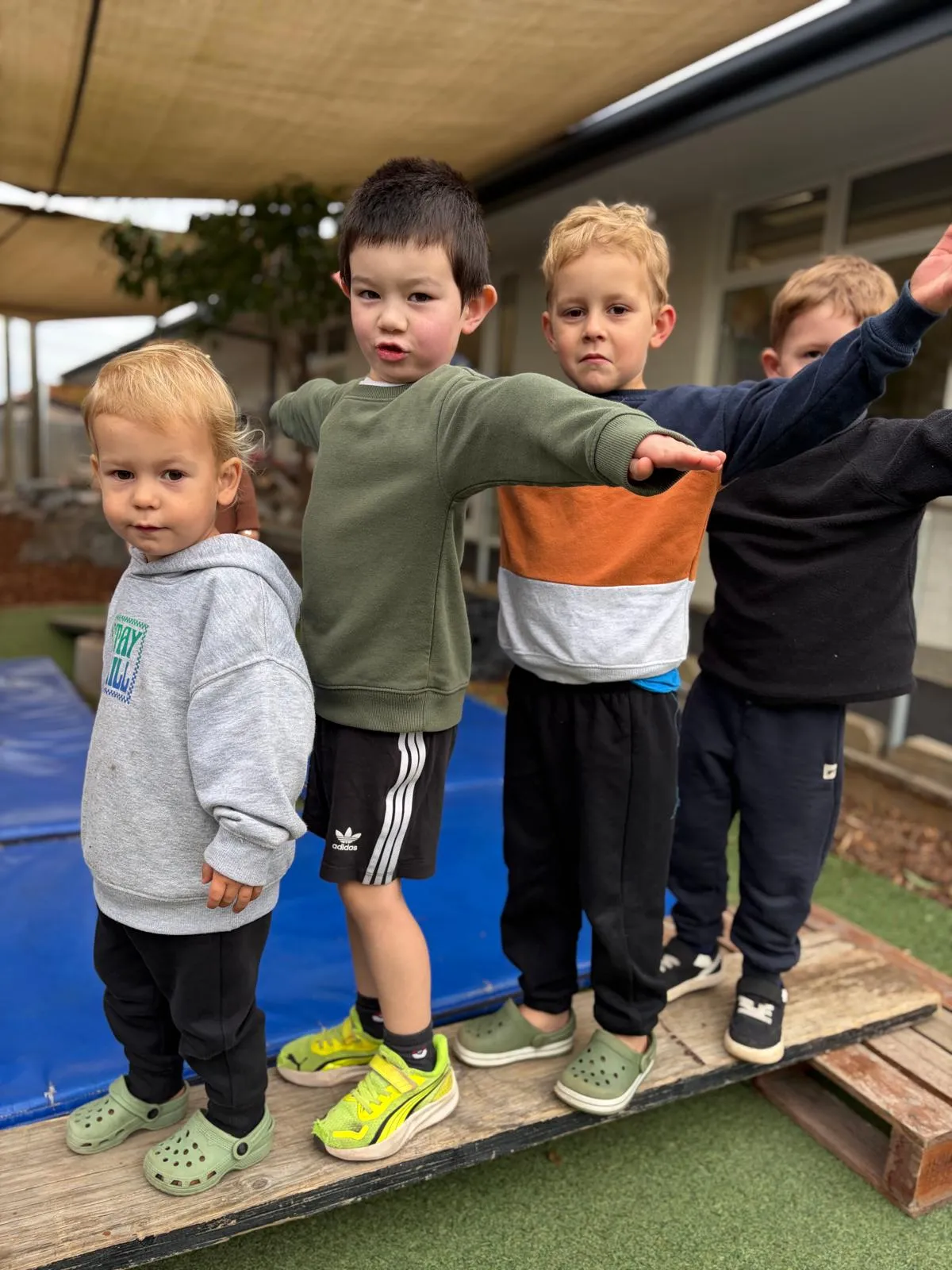 Tamariki balancing along the wooden beam in the Wonderhub playground